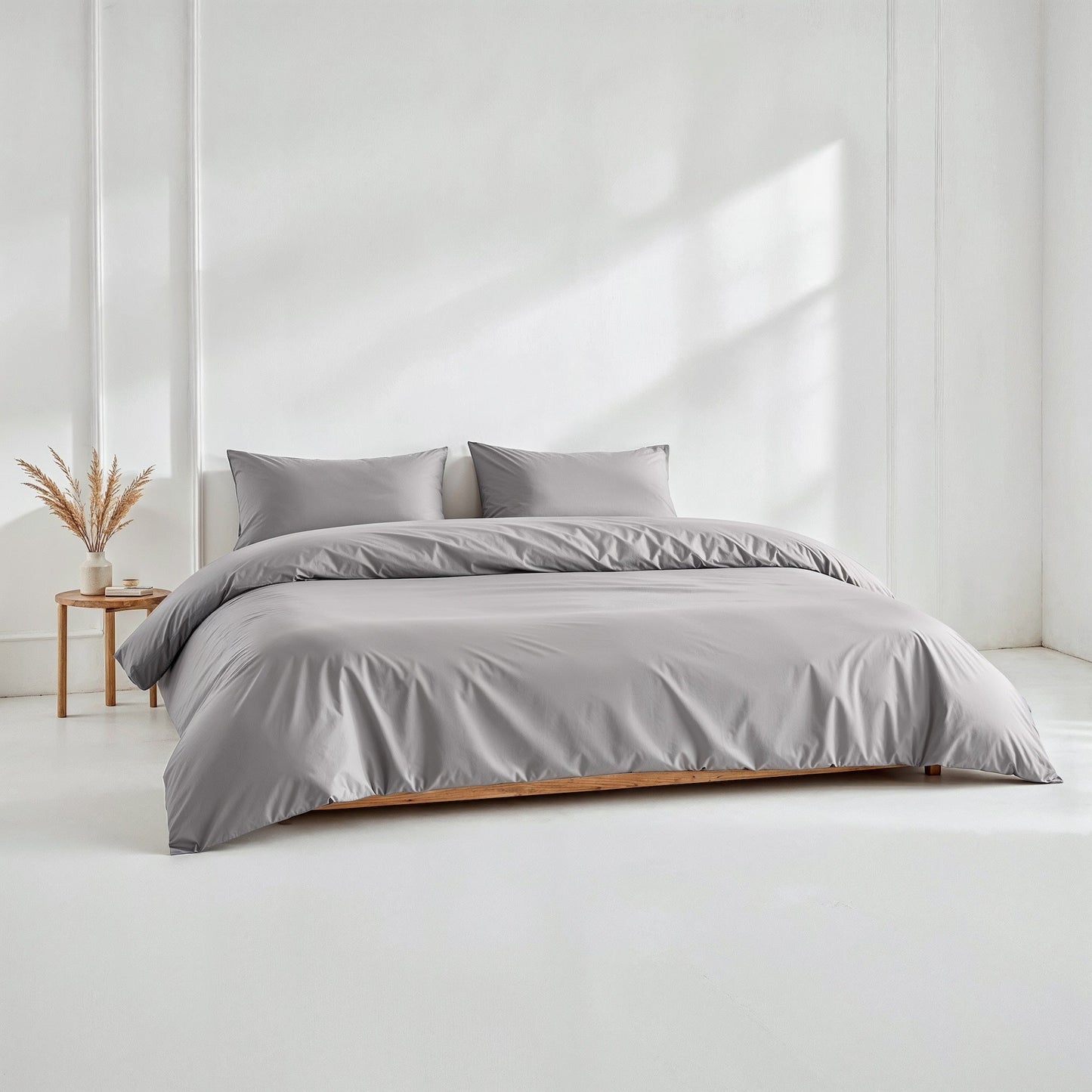 Sateen bedding bundle on bed with gray duvet and two matching pillows