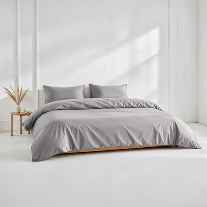 Sateen bedding bundle on bed with gray duvet and two matching pillows