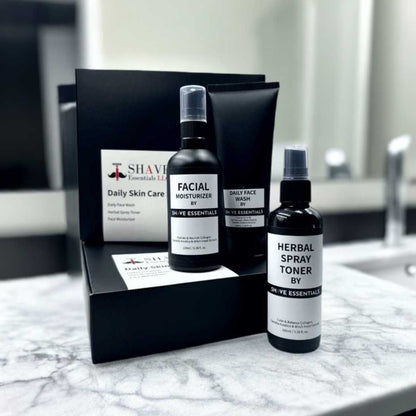 Skincare kit with black box and three facial bottles