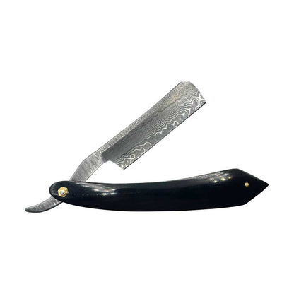 Damascus straight razor with glossy black handle, gold pin details, raised damascus blade