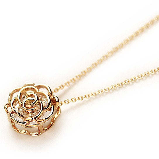 Gold-toned rose pendant with ornate filigree and matching chain links