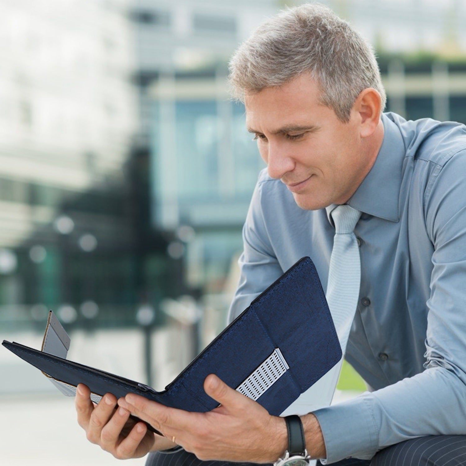 Black padfolio case held by a man with the front cover open