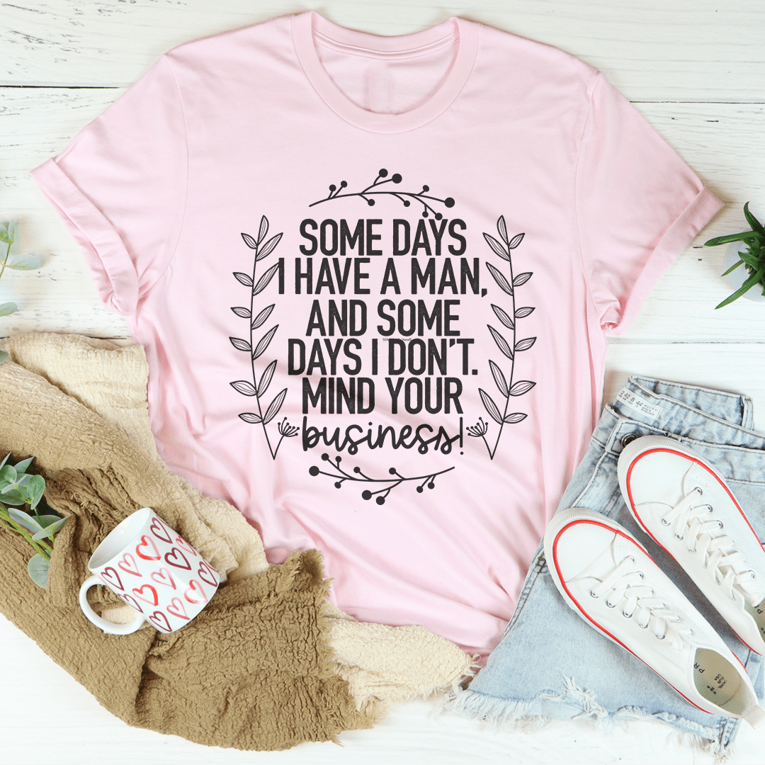 Pink crew-neck T-shirt with centered black quote and floral wreath graphic