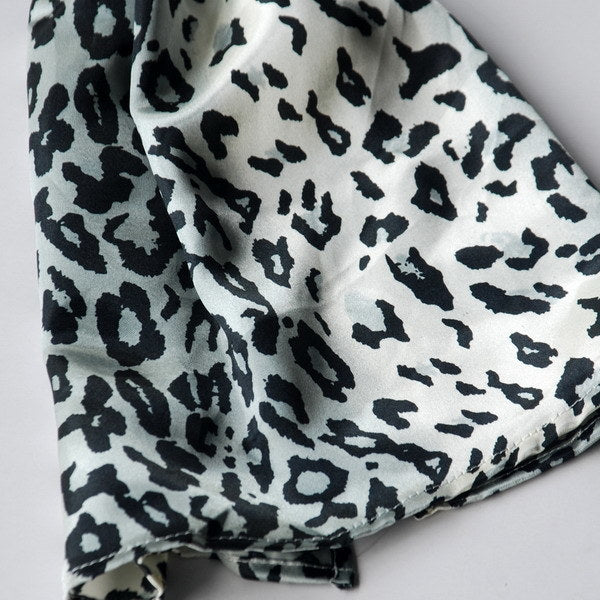 Close-up of black and white leopard print silk scarf fabric