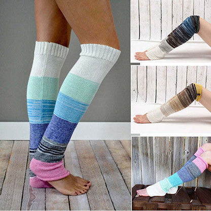 Knee-high socks on feet with white cuff, blue-green stripe pattern, pink accent.