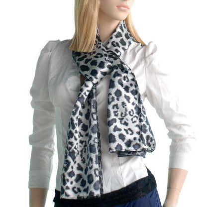 Leopard print silk scarf worn around the neck with draped ends, black and white