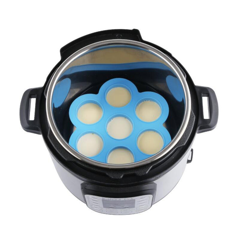 Blue 7-cavity silicone egg bite mold insert inside an electric cooker