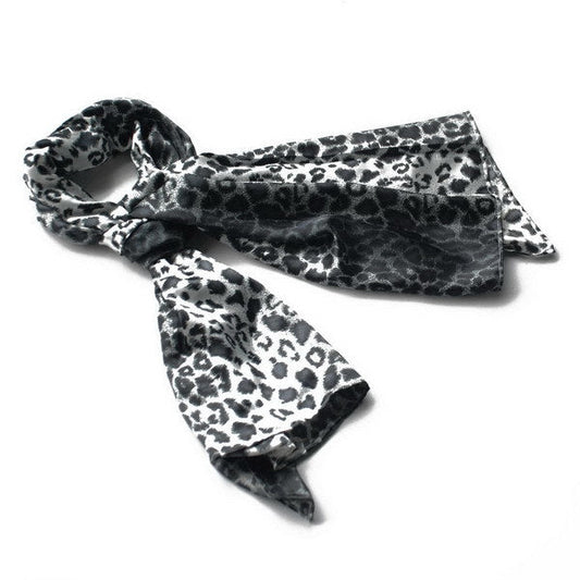 Leopard-print silk scarf in black and white, folded with pointed ends