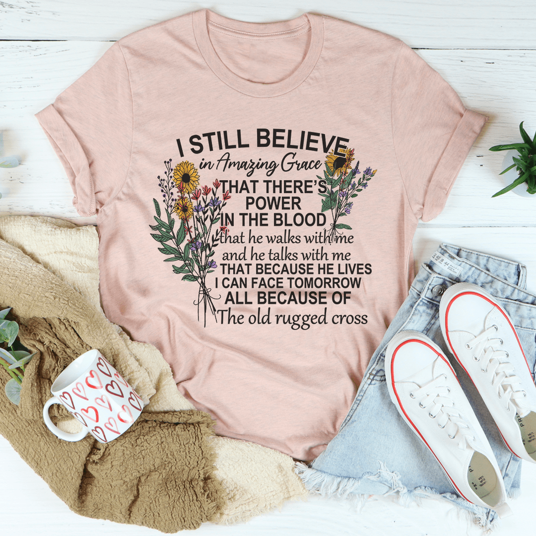 Dusty pink crewneck T-shirt with floral cross graphic and 'I STILL BELIEVE' lettering