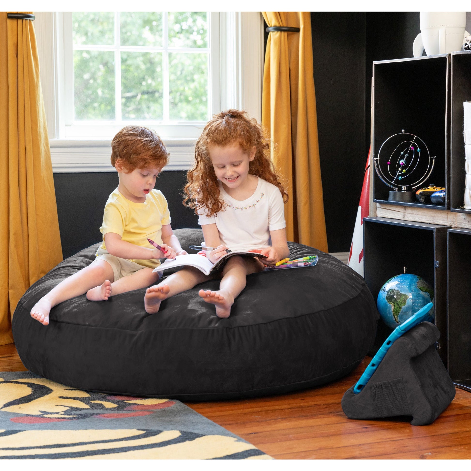Black kids cocoon bean bag with microsuede fabric, children reading inside.