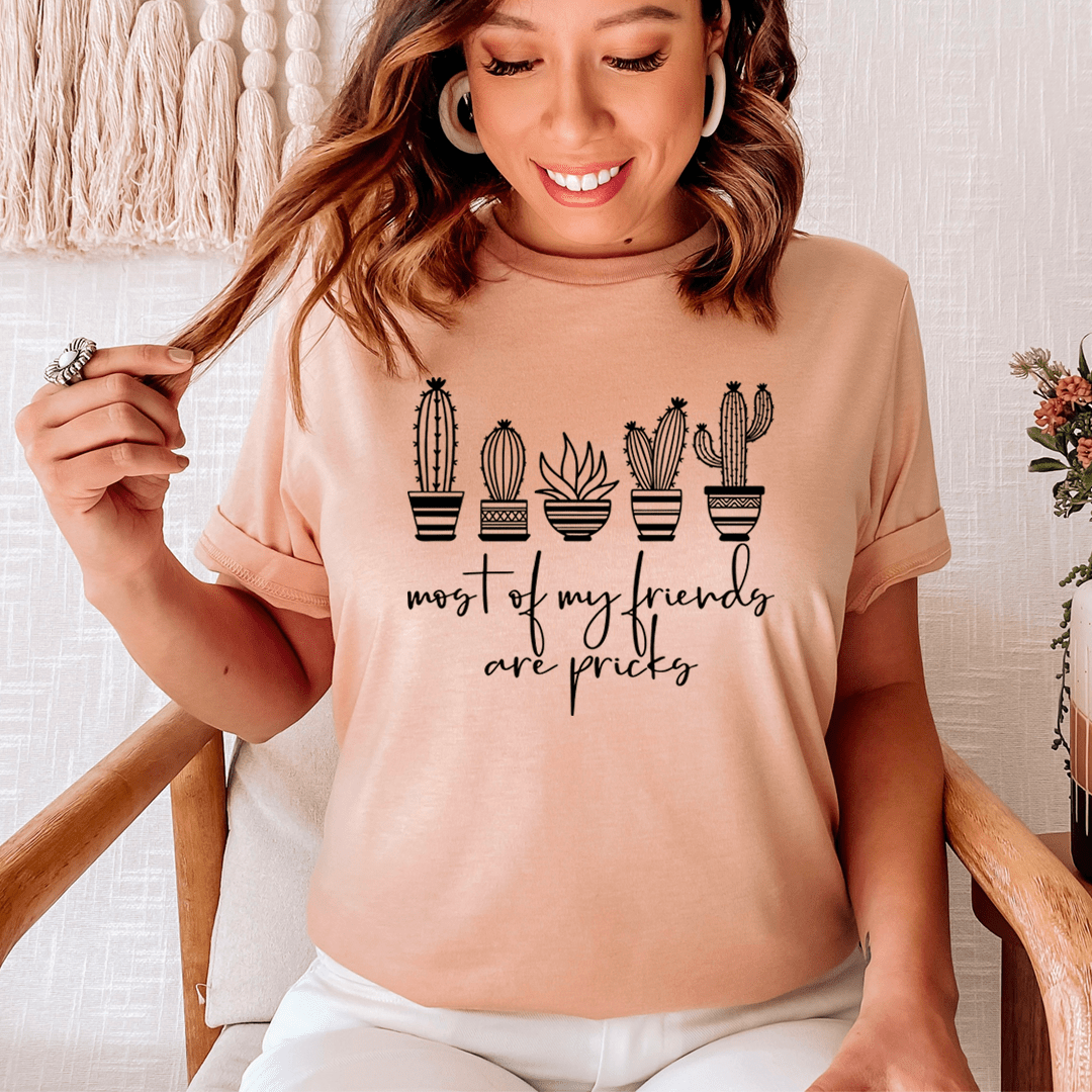 Peach crew-neck T-shirt worn by model, cactus graphic and 'most of my friends are pricks'