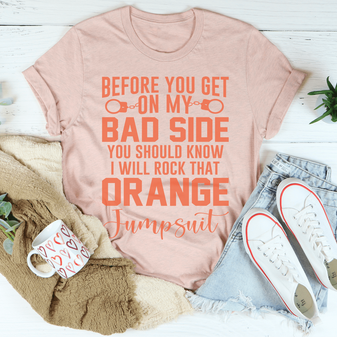 Peach T-shirt with crew neck and orange “Bad Side” graphic text