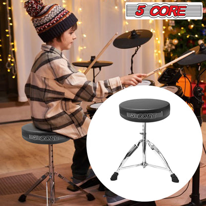 Black padded round drum stool with chrome tripod legs while a musician plays.