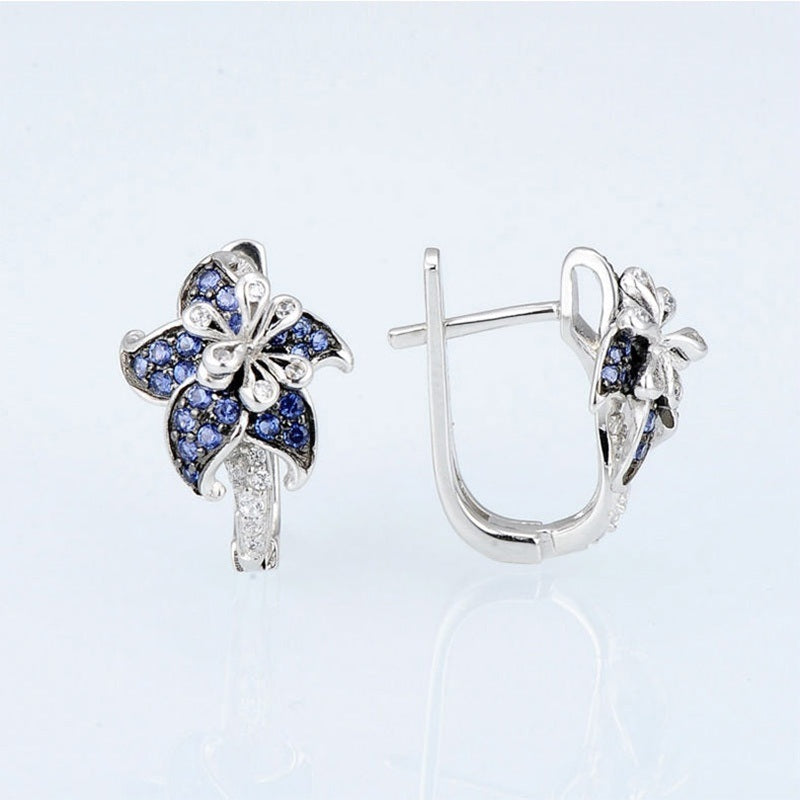 Silver-tone stud earrings with blue double-flower design and vertical clear zircon bar