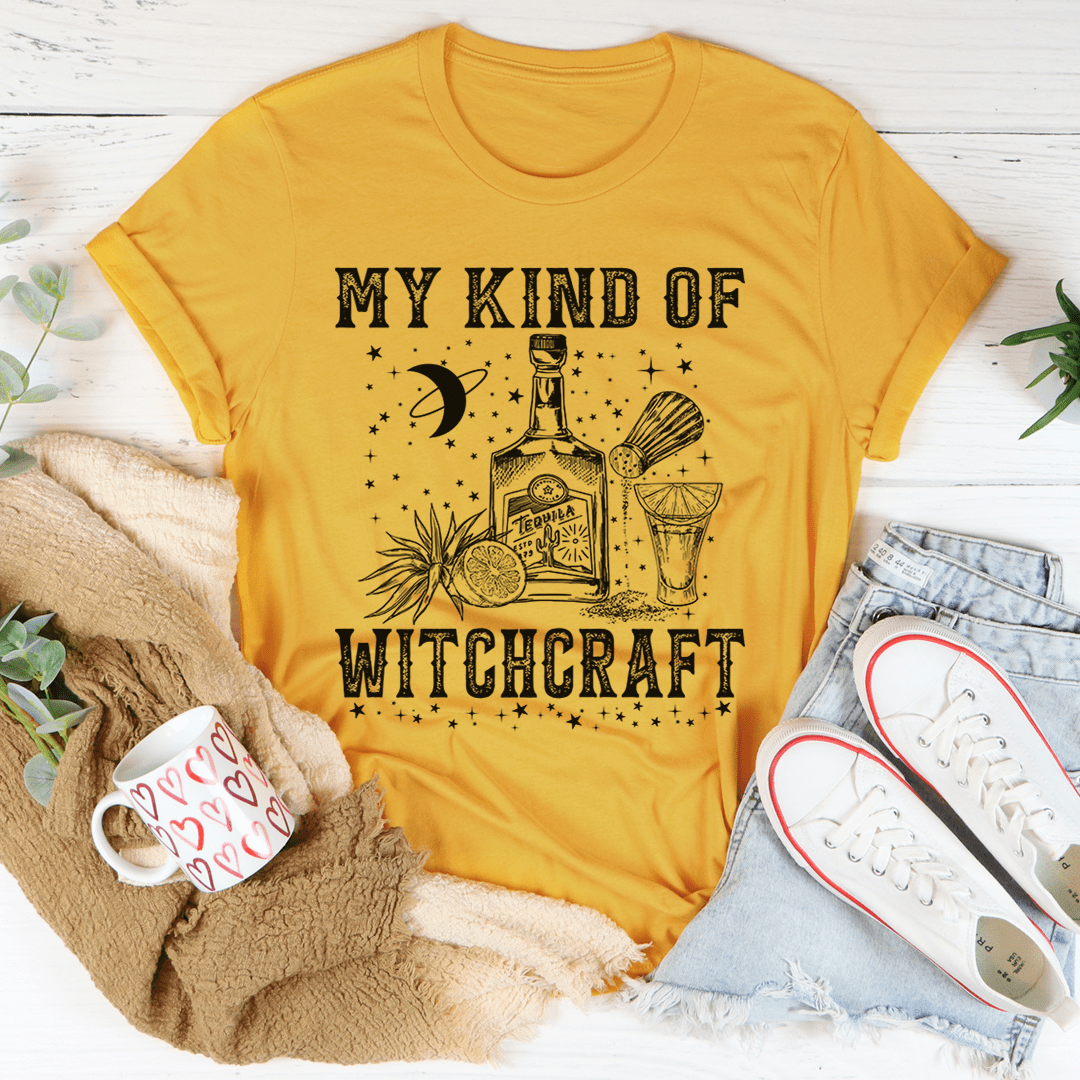 Mustard yellow crew-neck T-shirt with witchcraft-themed graphic in black on the chest.