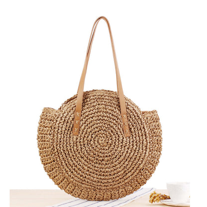 Handmade straw tote bag with woven shell pattern and tan leather-look handles