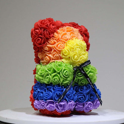 Multicolor rose teddy bear with red, orange, green, and blue layers plus ribbon