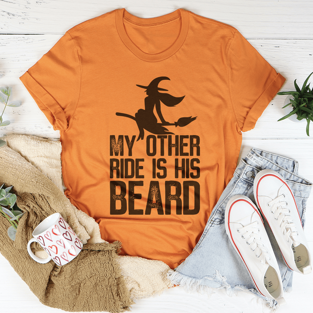 Orange T-shirt with cowboy graphic and bold stacked 'My Other Ride Is His Beard'