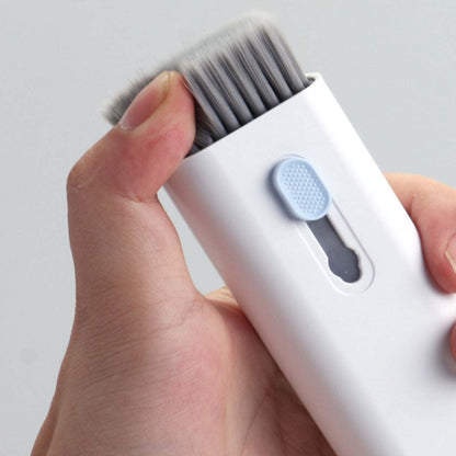 White multi-tool cleaner head with gray bristles, held in hands