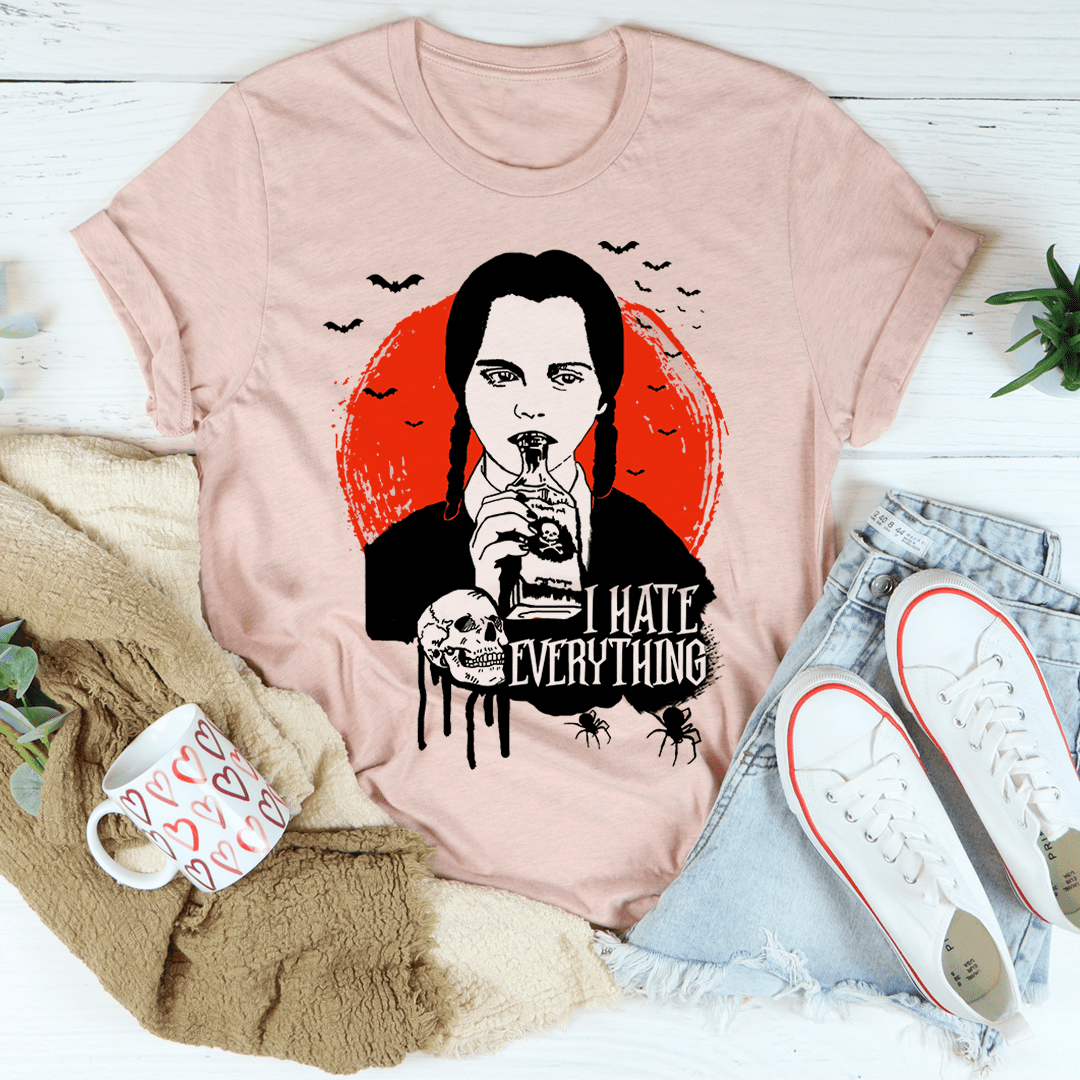 Blush pink graphic T-shirt with front portrait artwork and "I HATE EVERYTHING"