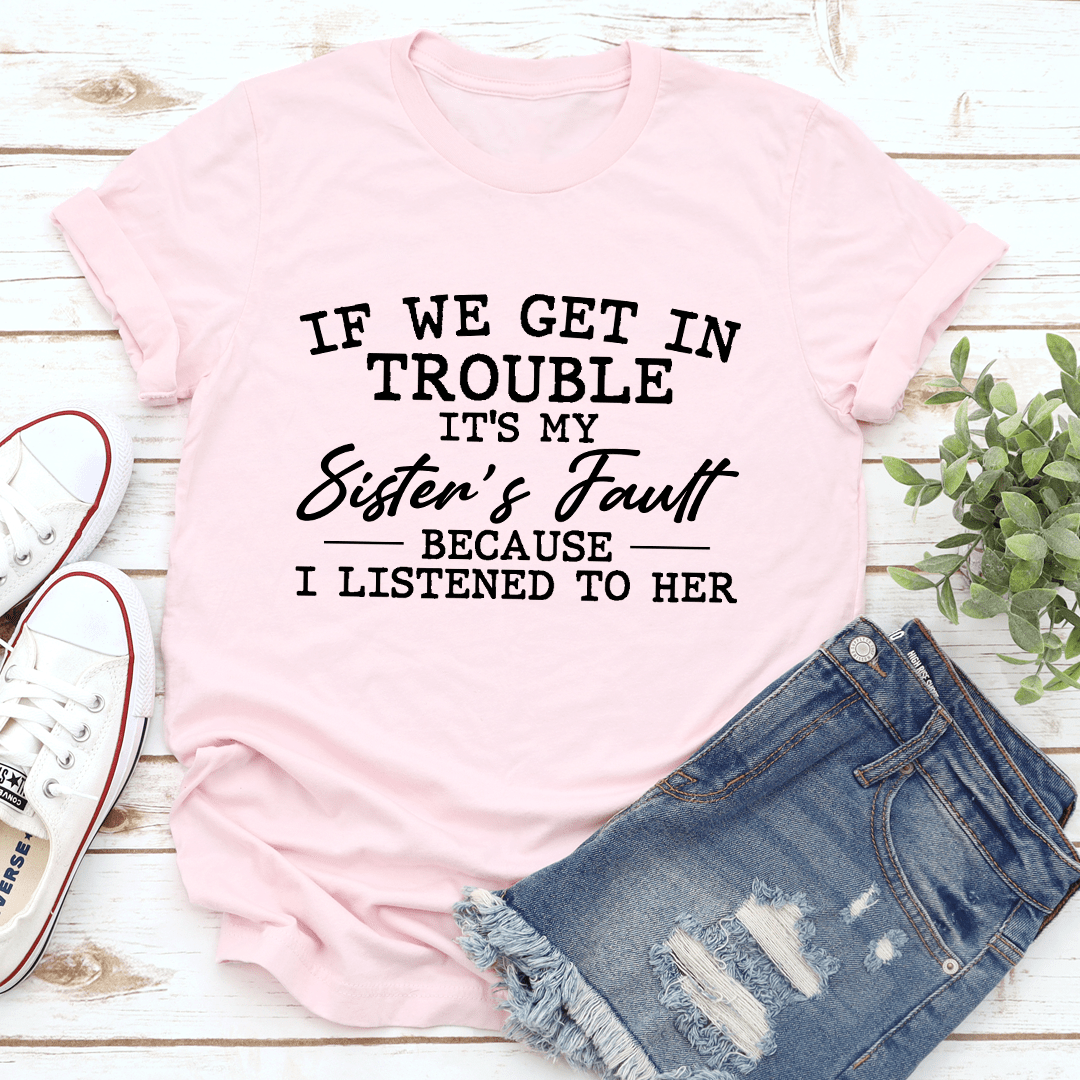 Light pink crewneck T-shirt with front slogan graphic: “If We Get In Trouble”