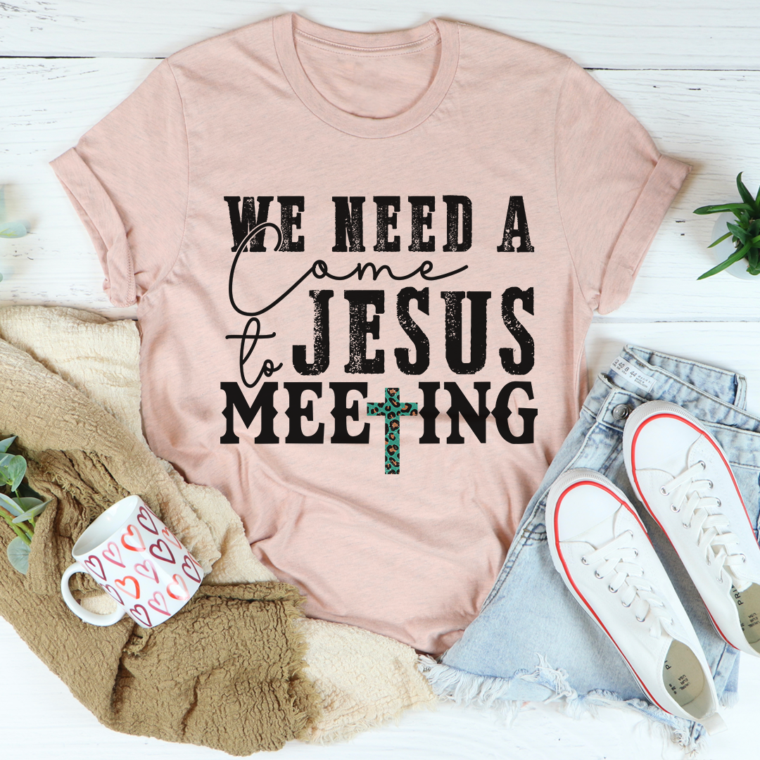 Light pink crewneck T-shirt with black typographic graphic and teal cross detail