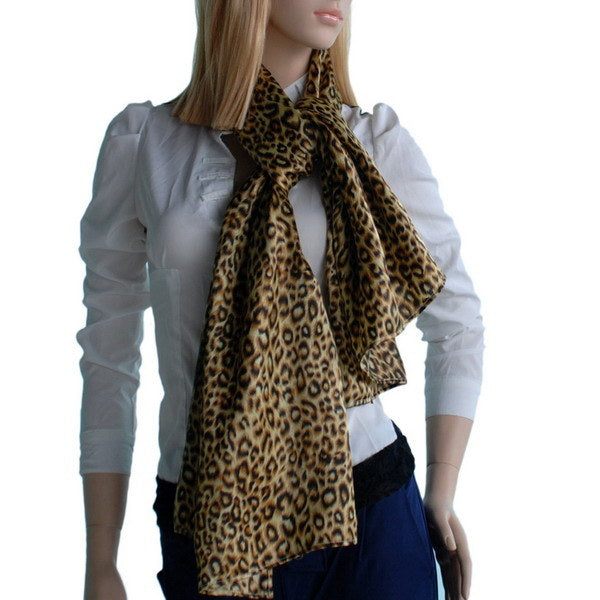 Leopard print silk scarf draped in front, brown and black; tied neck wrap.