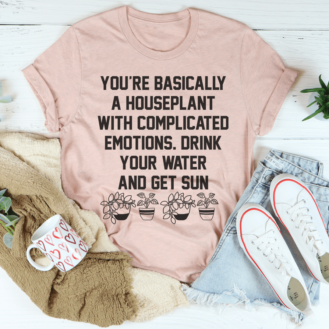 Peach houseplant quote graphic T-shirt with black lettering on the front