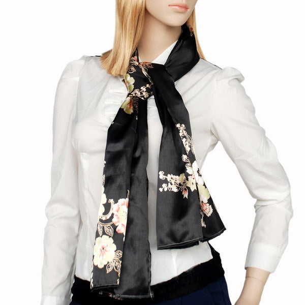 Black floral silk scarf worn as a neck tie, pastel blossoms on dark satin