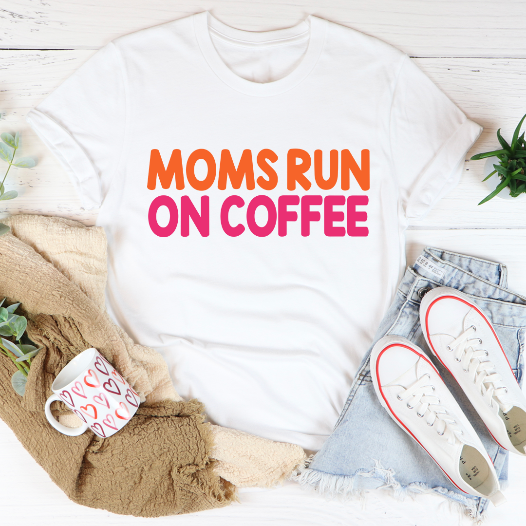 White T-shirt with 'MOMS RUN ON COFFEE' graphic in orange and pink