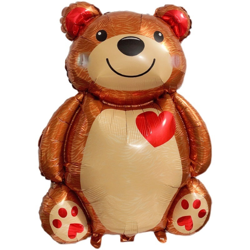 Brown bear foil balloon close-up with red heart on white belly