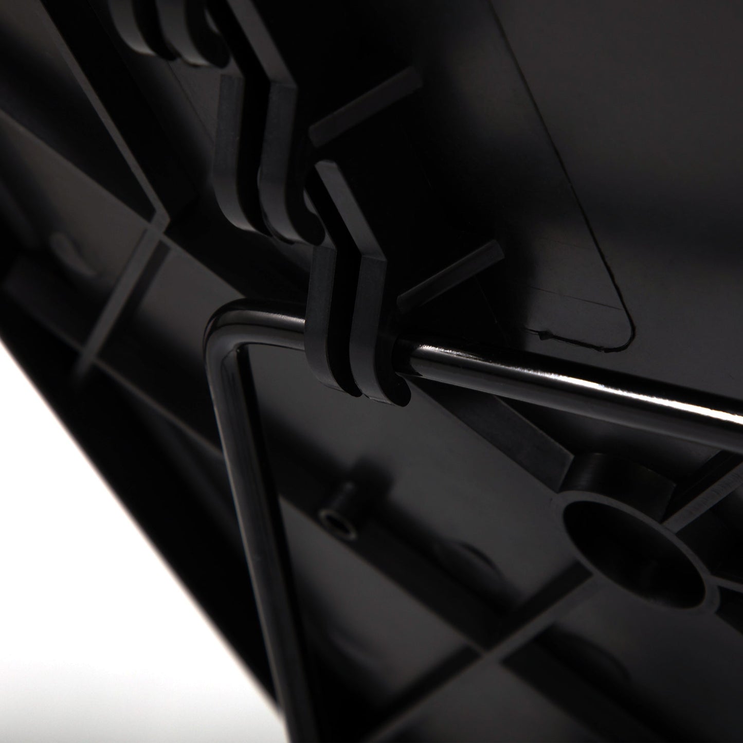 Close-up of black tray table hinge and adjustment mechanism