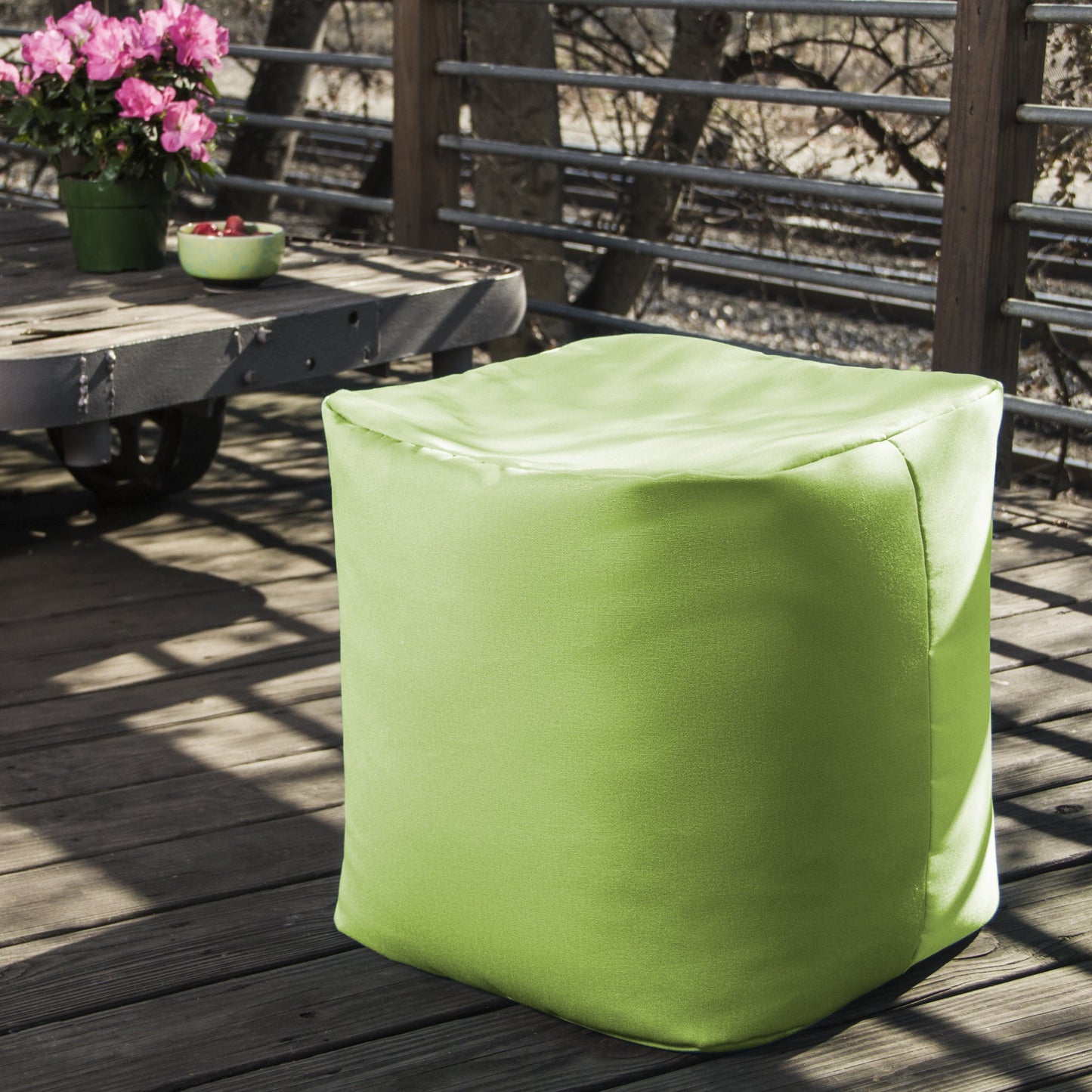 Lime bean bag ottoman, square fabric seat with visible corner seams on the sides.