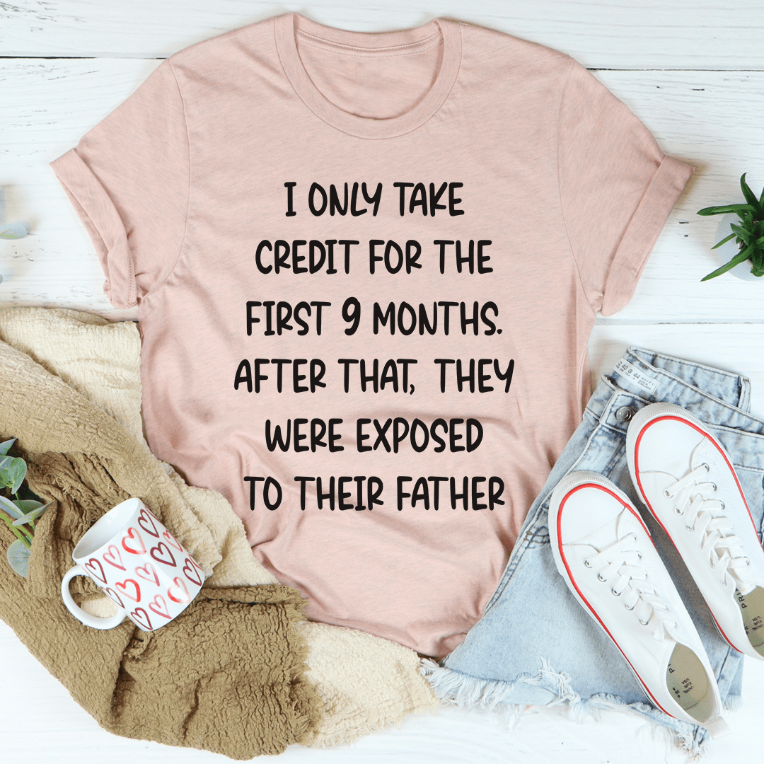 Dusty pink crewneck T-shirt with bold black text graphic on the front