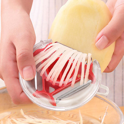 Vegetable and fruit peeler with red blade, creating ribbon slices on pale produce