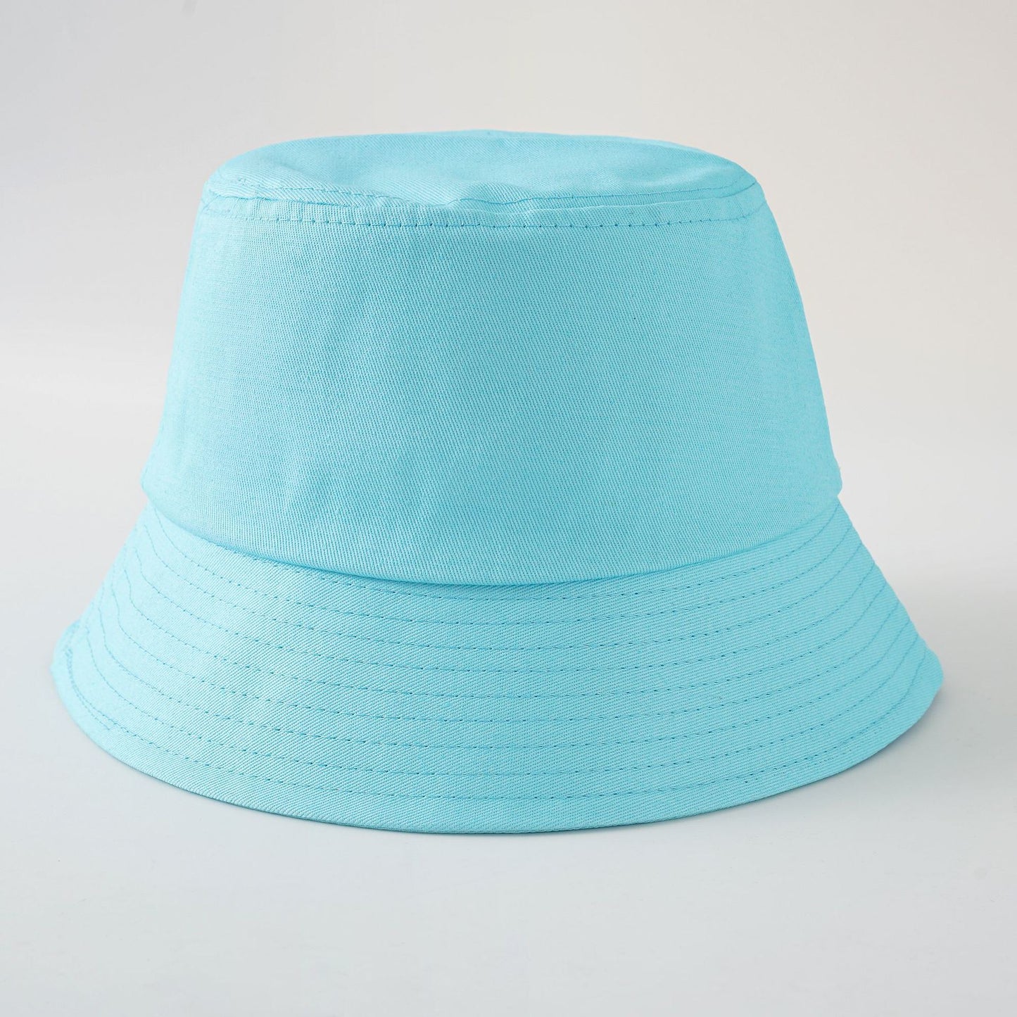 Sky blue fabric fisherman hat with wide brim and stitched decorative rows