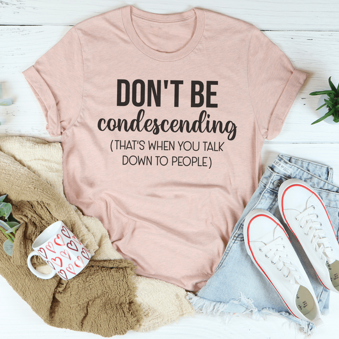 Pink crewneck T-shirt with "DON'T BE condescending" slogan on front.