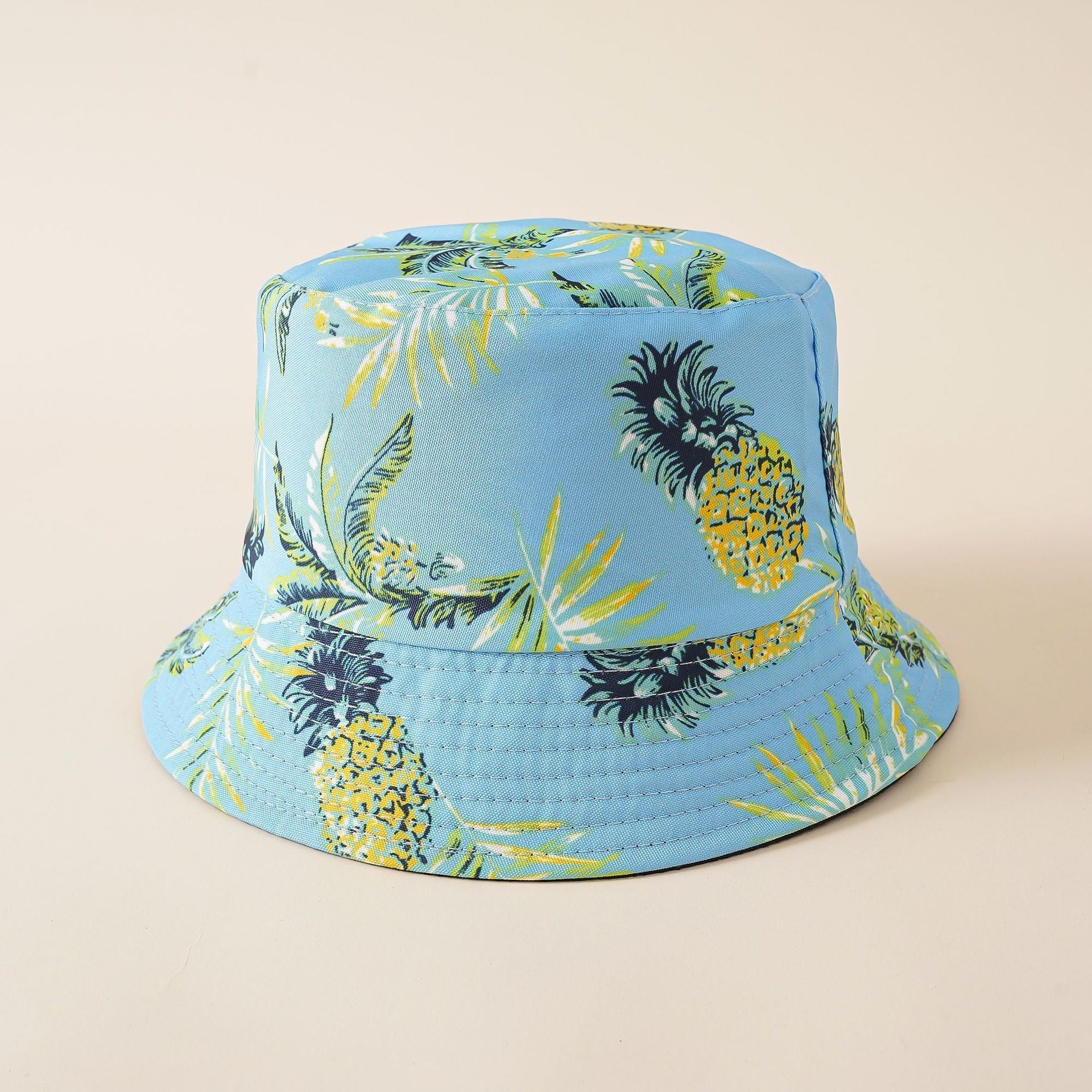Light blue fisherman hat with pineapple and palm-leaf tropical print, wide brim