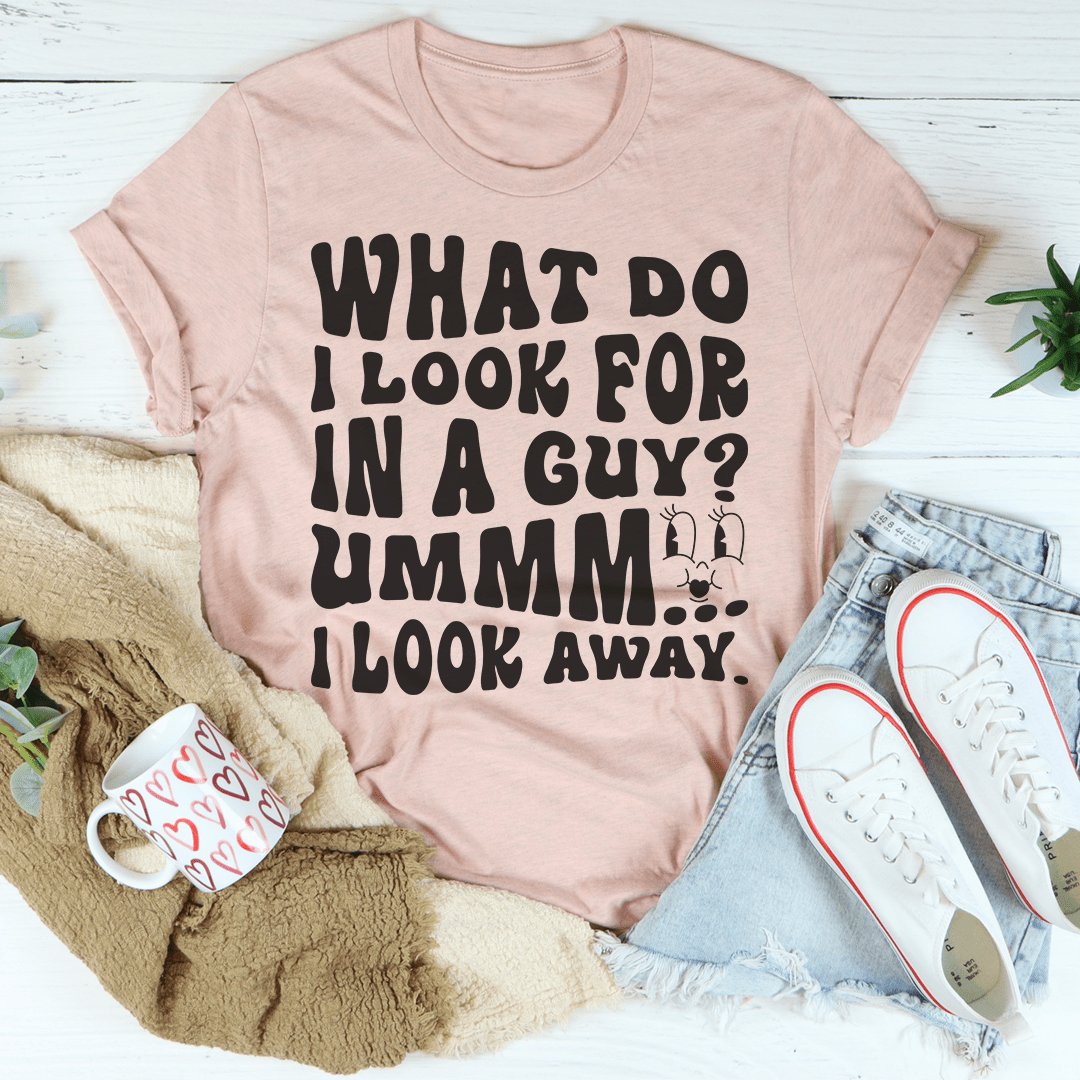 Heather peach T-shirt with bold black 'What do I look for...' text graphic