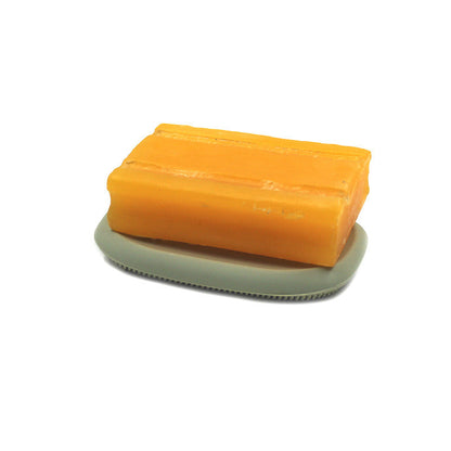 2-in-1 silicone soap holder, orange soap block on light green soap dish with brush pad