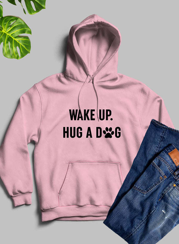 Mauve pink hoodie with hood, front pocket, and 'WAKE UP. HUG A DOG' chest print.