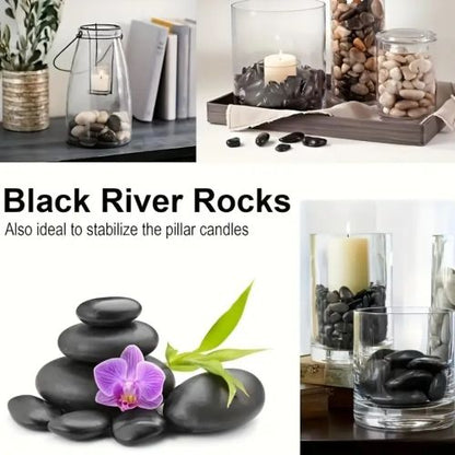 Polished black river rocks in a glass candle holder, smooth dark oval stones