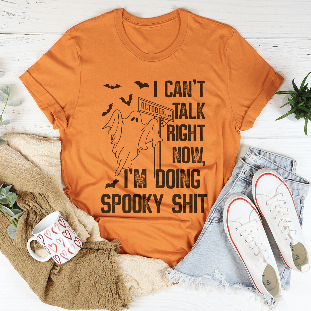 Burnt orange spooky T-shirt with haunted speech graphic and bold slogan