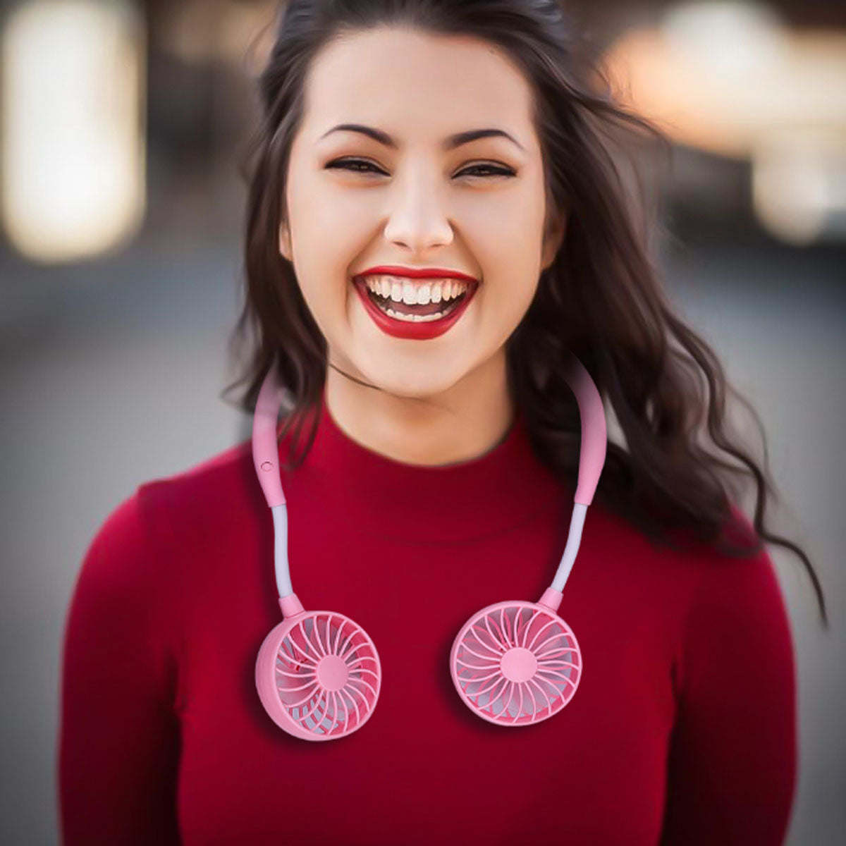 Mini cordless neck fan worn on collar with pink headband and pink fan units