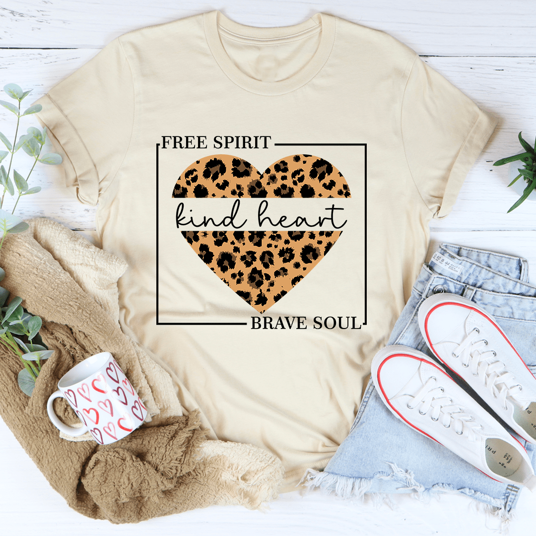 Soft cream T-shirt featuring a leopard heart print with “Brave Soul” below the design