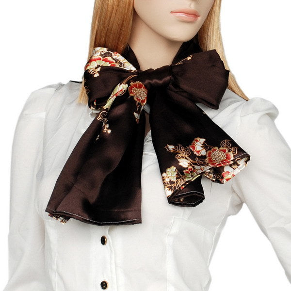 Silk floral scarf tied in a bow on the neck, dark brown with gold and red blossoms