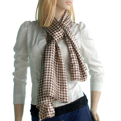 Silk scarf with brown and cream houndstooth plover pattern, draped around neck
