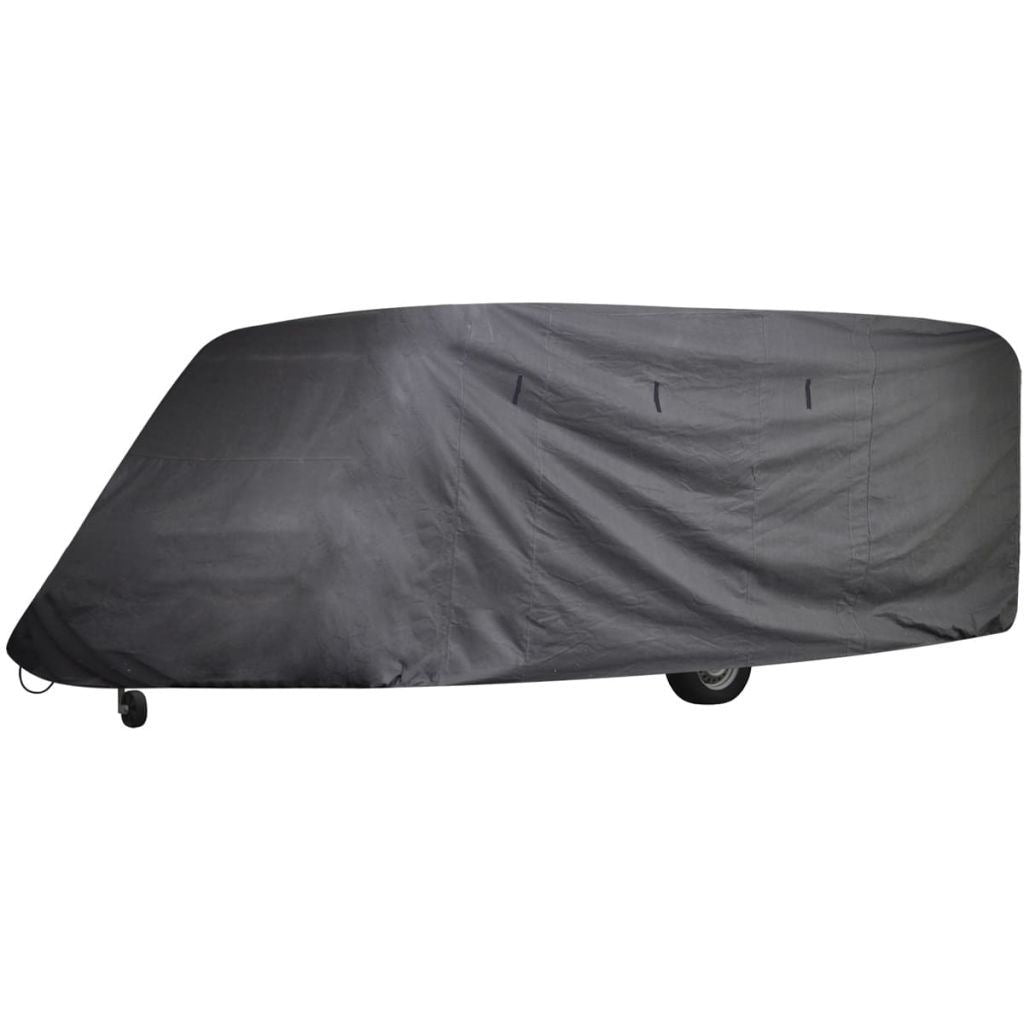 Dark gray caravan cover stretched over travel trailer roof and sides