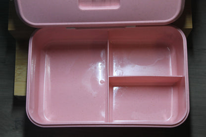 Pink bento box open with two compartments and divider