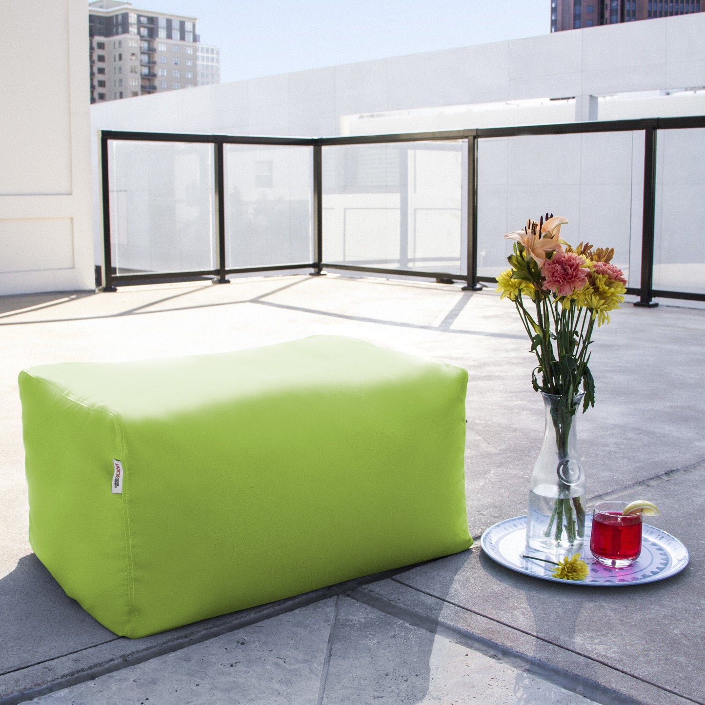 Lime bean bag ottoman with rectangular shape and corner stitching.